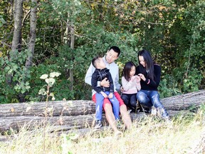 A young family explores an urban forest in the Crystallina Nera community.