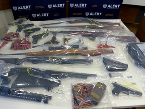 Some of the guns and ammunition seized in a search warrant executed at a Drayton Valley residence on Mar. 21. Law enforcement also seized a quantity of marijuana and prescription pills. Eight people were arrested.