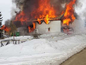 Flames engulf the Buck Lake Lakeshore Inn on Mar. 23.