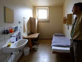 A justice officer stands in a prison cell of the Landsberg prison, in Landsberg, southern Germany, is pictured on March 31, 2014. The former FC Bayern Munich President Uli Hoeness will start his prison sentence in the Landsberg prison. (AFP PHOTO/CHRISTOF STACHE)