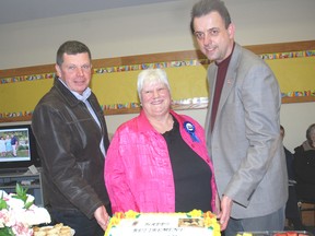 Dutton/Dunwich Mayor Cameron McWilliam, left joins Mary Lou McMillan at her retirement party from John Kenneth Galbratih Reference Library branch in Dutton with Brian Masschaele, director of cultural services for Elgin County.