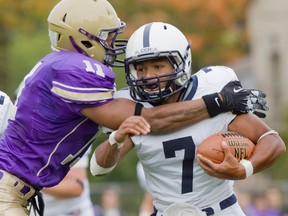 Central Golden Ghost Nate Behar tackles CCH Crusader Adrien McMillan during a high school football game in 2012. (Free Press file photo)