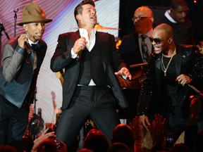 Pharrell Williams, left, Robin Thicke, centre, and T.I. perform Blurred Lines at the Clive Davis Pre-Grammy Gala and Salute to Industry Icons in Beverly Hills, Calif., on Jan. 25. (Phil McCarten/Reuters)