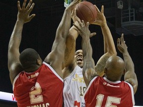 The London Lightning's Dwight McCombs shoots over  DeAndre Thomas and Quinnel Brown of the Windsor Express during their NBL playoff game at Budweiser Gardens in London, Ont. on Saturday March 29, 2014. (DEREK RUTTAN, The London Free Press)