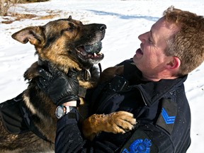 Cst. Mike Garth and PSD Quattro of the Canine Unit pose for photos at Malcolm Groat Park in Edmonton on Monday, March 31, 2014. (CODIE MCLACHLAN/Edmonton Sun)