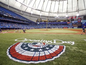 The grounds crew readies the turf before the start of the Jays-Rays game at Tropicana Field in St. Petersburg on Monday. (AFP/PHOTO)