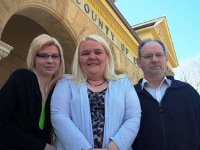 Wendy Rivait, 43, centre, stands with her daughter Tasha Couture, 17, and her husband Ray Couture, 52. Rivait served six months in jail for arson. Monday in 
St. Thomas, the charge was with-drawn. (JANE SIMS, The London Free Press)