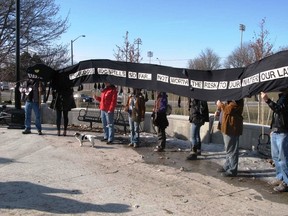 Protesters gathered at the forks of the Thames in London on Monday to create a human snake in a demonstration against Enbridge?s Line 9.  (DAN BROWN, The London Free Press)