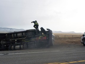 A photo from January of last year shows PCES member Michael Whittington climbing over an overturned truck on Hwy. 22 north of Hwy. 3. Greg Cowan photo/QMI agency.