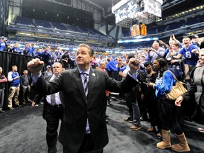 Kentucky Wildcats head coach John Calipari waves to the crowd as he leaves the court after defeating the Michigan Wolverines in the final of the midwest regional of the 2014 NCAA Mens Basketball Championship tournament at Lucas Oil Stadium. (Thomas J. Russo-USA TODAY Sports)