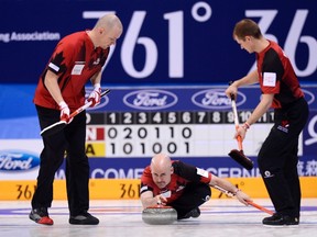Canada's skip Kevin Koe (C) delivers a stone between his teammates in a match against the United States during their World Men's Curling Championships in Beijing, April 1, 2014. (REUTERS)