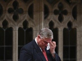 Liberal MP Jim Karygiannis wipes his eyes while announcing his resignation in the House of Commons on Parliament Hill in Ottawa April 1, 2014. REUTERS/Chris Wattie