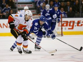 Toronto's Joffrey Lupul chases Kris Russell of Calgary as the Maple Leafs host the Calgary Flames at the Air Canada Centre in Toronto on Tuesday, April 1, 2014. Michael Peake/Toronto Sun)