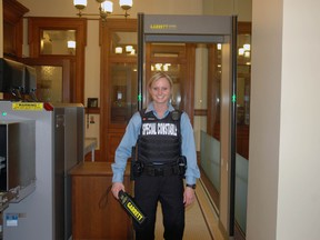 Special Constable Keshia Jacklin of the St. Thomas Police Service stands next to screening equipment in the entrance to the Elgin County Courthouse in St. Thomas on Tuesday, April 1, 2014. Ben Forrest/Times-Journal