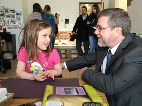 JOHN LAPPA/THE SUDBURY STAR        
Norm Blaseg, Director of Education for the Rainbow District School Board, talks to Lilliana MacIsaac, 4, during a tour of the new MacLeod Public School on Tuesday. Students in junior kindergarten to Grade 2 and the daycare have moved into the new school, while Grade 3 to Grade 8 students will move to the school on Walford Road in September 2014.