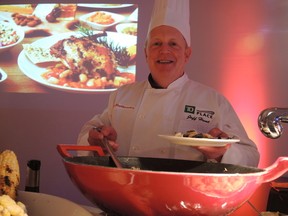 OSEG president of sports Jeff Hunt samples food at the Museum of Nature Tuesday night. Time Baines/Ottawa Sun