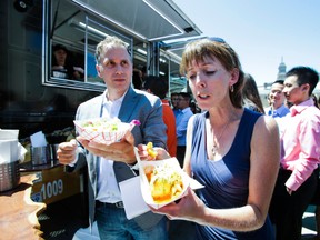 Councillors Mary-Margaret McMahon and Josh Colle enjoy food truck fare Nathan Phillips Square. (Toronto Sun files)