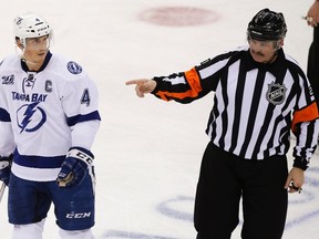 Referee Don Van Massenhoven points toward the bench as Tampa Bay Lightning's Vincent Lecavalier (4) argues with him after the team was given two penalties and then a bench minor as they played the New Jersey Devils in the third period of their NHL hockey game in Newark, New Jersey, February 7, 2013. (REUTERS)