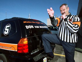 National Hockey League referee Don Van Massenhoven posses with his jersey at a car dealership on Oct. 12, 2004. (DAVE CHIDLEY/London Free Press/QMI Agency)
