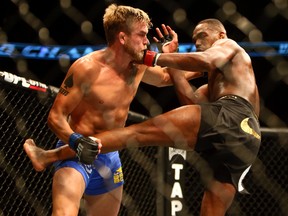 Jon Jones (red) defeats Alexander Gustafsson (blue) during the light heavyweight championship bout during UFC 165 at the Air Canada Centre on Sept. 22, 2013. (Dave Abel/Toronto Sun/QMI Agency)