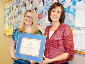 Naomi Pelss, director of the Seaforth Cooperative Children’s Centre accepts an award of Employer of Distinction for 2014 from Jenni Helm, of the Conestoga Career Centre.