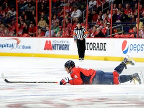 Alex Ovechkin of the Washington Capitals is tripped up during the first period against the Edmonton Oilers at the Verizon Center on October 14, 2013. (Greg Fiume/Getty Images/AFP)