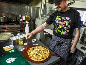 Mark Klokeid, co owner of Mega ill cafe brushes pot-infused oil on the pizza crust at his restaurant in Vancouver, B.C. on Wednesday April 2, 2014. Mega Ill Cafe let's you add pot, marijuana to your pizza for $10. If you're 18 and have a cannabis card.

Carmine Marinelli/QMI AGENCY