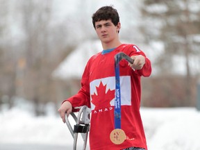 Ben Delaney of Ottawa shows the bronze medal he won for sledge hockey at the Sochi Paralympics. Tony Caldwell/Ottawa Sun