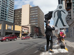 A pedestrian marker was put up on Rideau Street near Waller Street in Ottawa On. Wednesday April 2,  2014. Yvonne Hendrikx was hit and killed on Feb 21 at that intersection and Ottawa police are still looking for the driver of the truck who hit her.  Tony Caldwell/Ottawa Sun/QMI Agency