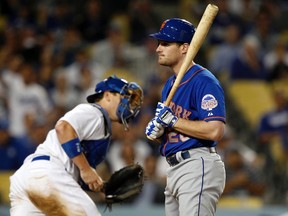 New York Mets' Daniel Murphy (R) reacts after striking out as Los Angeles Dodgers catcher A.J. Ellis returns to the dugout in the eighth inning of their MLB National League baseball game in Los Angeles, California August 13, 2013. (REUTERS)