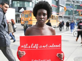 Serenity Hart, Nude model stands at the corner of Yonge and Dundas Sts, in Toronto on Wednesday April 2, 2014. She is raising awareness surrounding the rights of Canadian women to bare their chest in public. (Veronica Henri/QMI Agency)