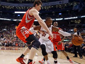 The Raptors’ Terrence Ross (right) is hounded by Donatas Moliejunas of the Houston Rockets last night at the Air Canada Centre. Ross had nine rebounds and 14 points in the game. (MICHAEL PEAKE/Toronto Sun)