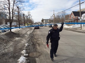 Gatineau Police spokesman Pierre Lanthier walks under police tape at the scene of a suspicious package which has resulted in the evacuation of an area bordering 95 Lois St. (DARREN BROWN Ottawa Sun)
