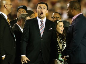 Former Texas A&M quarterback Johnny Manziel reacts to Levonte Whitfield #7 of the Florida State Seminoles scoring on a 100-yard kickoff return against the Auburn Tigers in the fourth quarter of the 2014 Vizio BCS National Championship Game at the Rose Bowl on January 6, 2014 in Pasadena, California.  (Jeff Gross/Getty Images/AFP)