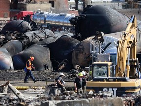 Emergency workers work on the site of the train wreck in Lac-Megantic, July 12, 2013. (REUTERS/Mathieu Belanger)