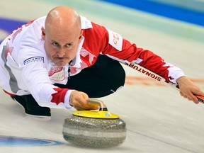 Canada skip Kevin Koe delivers a rock during his match against Scotland at the World Men's Curling Championships in Beijing, April 3, 2014. (REUTERS/China Daily)