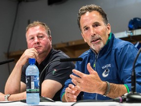 Vancouver Canucks' general manager Mike Gillis  (left) and coach John Tortorella (right) speak to the media during training camp at Rogers Arena in Vancouver, B.C., Wednesday September 11, 2013. (CARMINE MARINELLI/QMI Agency)
