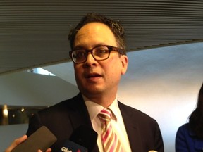 Public Works chairman Denzil Minnan-Wong speaks to reporters about potholes at City Hall on Wednesday. (DON PEAT/Toronto Sun)