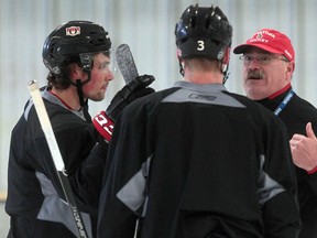 Senators coach Paul MacLean talks to Cody Ceci and Marc Methot during practice Thursday in Ottawa.  Tony Caldwell/Ottawa Sun