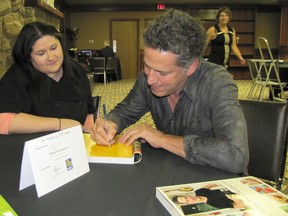 Celebrity chef Bob Blumer autographs a copy of his book Glutton For Pleasure for Stephanie Travis of T-Bones Grill House. He was in Chatham on Thursday for the Parade of Chefs event held at Club Lentinas.