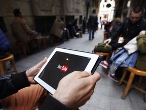 A man tries to connect to YouTube with his tablet at a cafe in Istanbul March 27, 2014. REUTERS/OSMAN ORSAL