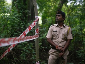 A policeman stands guard near the crime scene where a photo journalist was raped by five men inside an abandoned textile mill in Mumbai August 23, 2013. A photo journalist was gang-raped in the Indian city of Mumbai, police said on Friday, evoking comparisons with a similar incident in Delhi in December that led to nationwide protests and a revision of the country's rape laws. REUTERS/Danish Siddiqui