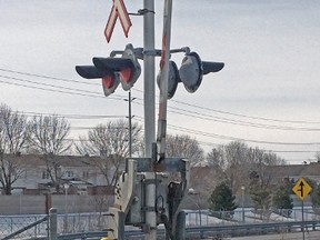 Via Rail repair crews work on malfunctioning signals at the Fallowfield Rd. crossing in Barrhaven on Friday morning, April 4, 2014. (TONY CALDWELL Ottawa Sun)