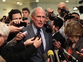 Sen. Dan Coats talks to the media in Washington in this November 16, 2012 file photo. (REUTERS/Yuri Gripas)