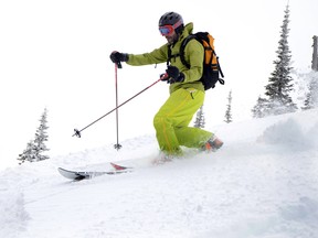 Cross country ski gold medallist Robin McKeever takes to the steep and deep powder for a change while cat skiing at Castle Mountain. John Stoesser photos/QMI Agency