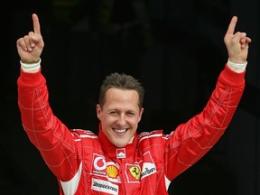 Michael Schumacher, who suffered serious head injuries in a December skiing accident, is making progress and showing signs of waking from an artificial coma, his agent said on April 4, 2014. (REUTERS/Caren Firouz/Files)