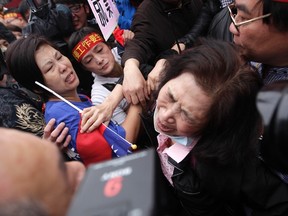 A woman cries during a rally near the Legislative Yuan, or Taiwan's parliament, in Taipei April 1. Hundreds of activists who support a controversial trade pact with mainland China marched on the streets to demonstrate against protesters of the pact who have been occupying the parliament building since March 18. 
REUTERS/Pichi Chuang
