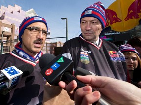 Coun. Amarjeet Sohi and Richard Starke, Alberta's minister of Tourism, Parks and Recreation, speak to the media in Crashed Ice jerseys, gloves and helmets at the Bull Crashed Ice announcement.