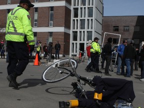 Carl the crash-test dummy lies in the street at Carleton University campus after being struck on the first attempt, as students forced a collision between a bicycle and a speeding car Friday morning.
(DOUG HEMPSTEAD/Ottawa Sun)