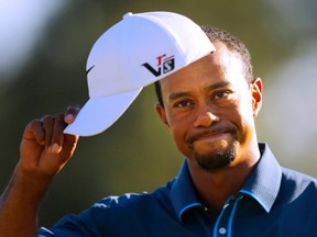 Tiger Woods of the U.S. tips his hat during third round play in the 2013 Masters golf tournament at the Augusta National Golf Club in Augusta, Georgia, in an April 13, 2013 file photo. (REUTERS/Brian Snyder/files)